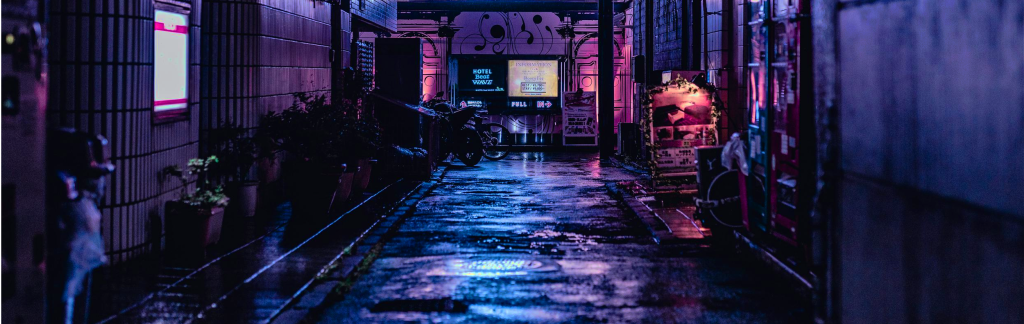 a darkly-lit image of an alley with a window at the end